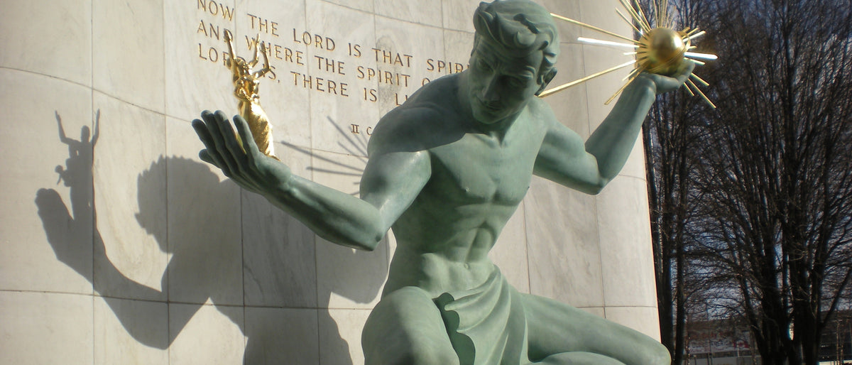 The Spirit of Detroit, the bronze figure on Woodward Avenue holding a gilt sphere and a family group