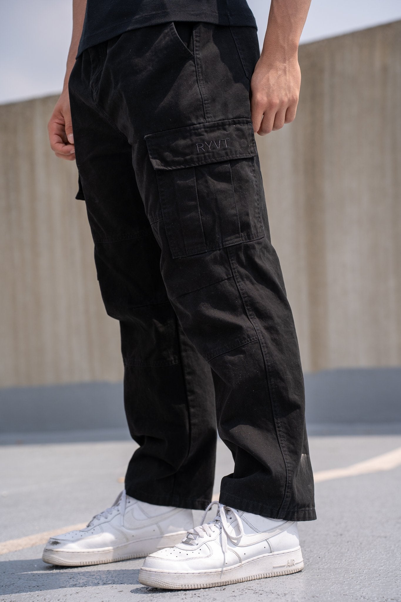 Black Standard-Issue Cargo Pants, on model, three-quarter view